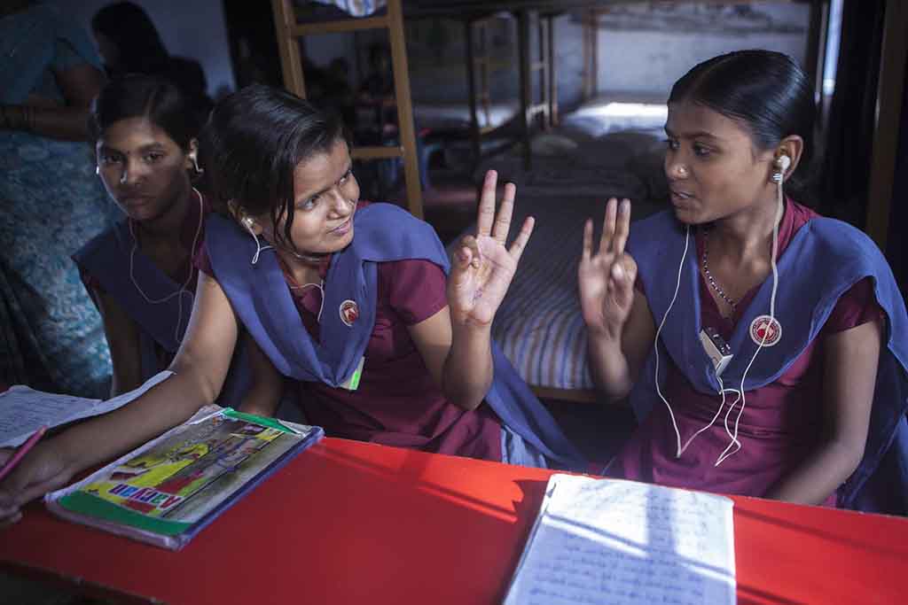 Primary school girls in Nalanda Bihar, Indian using signing to communicate in class. 