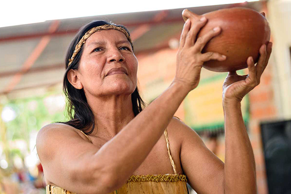 indigenous person holding calabash