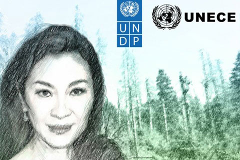 Michelle Yeoh with a forest in the background.